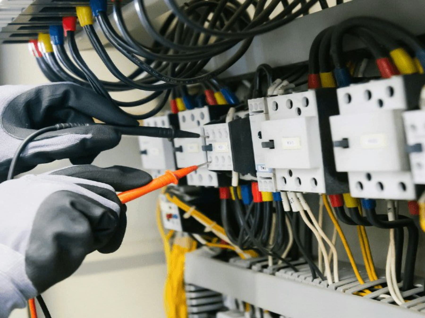 Multimeter testing on a commercial distribution board